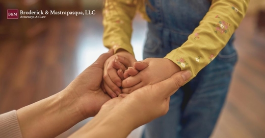 parent holding little child's hands