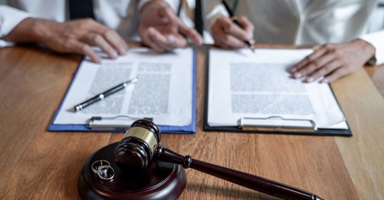 couple signing divorce papers